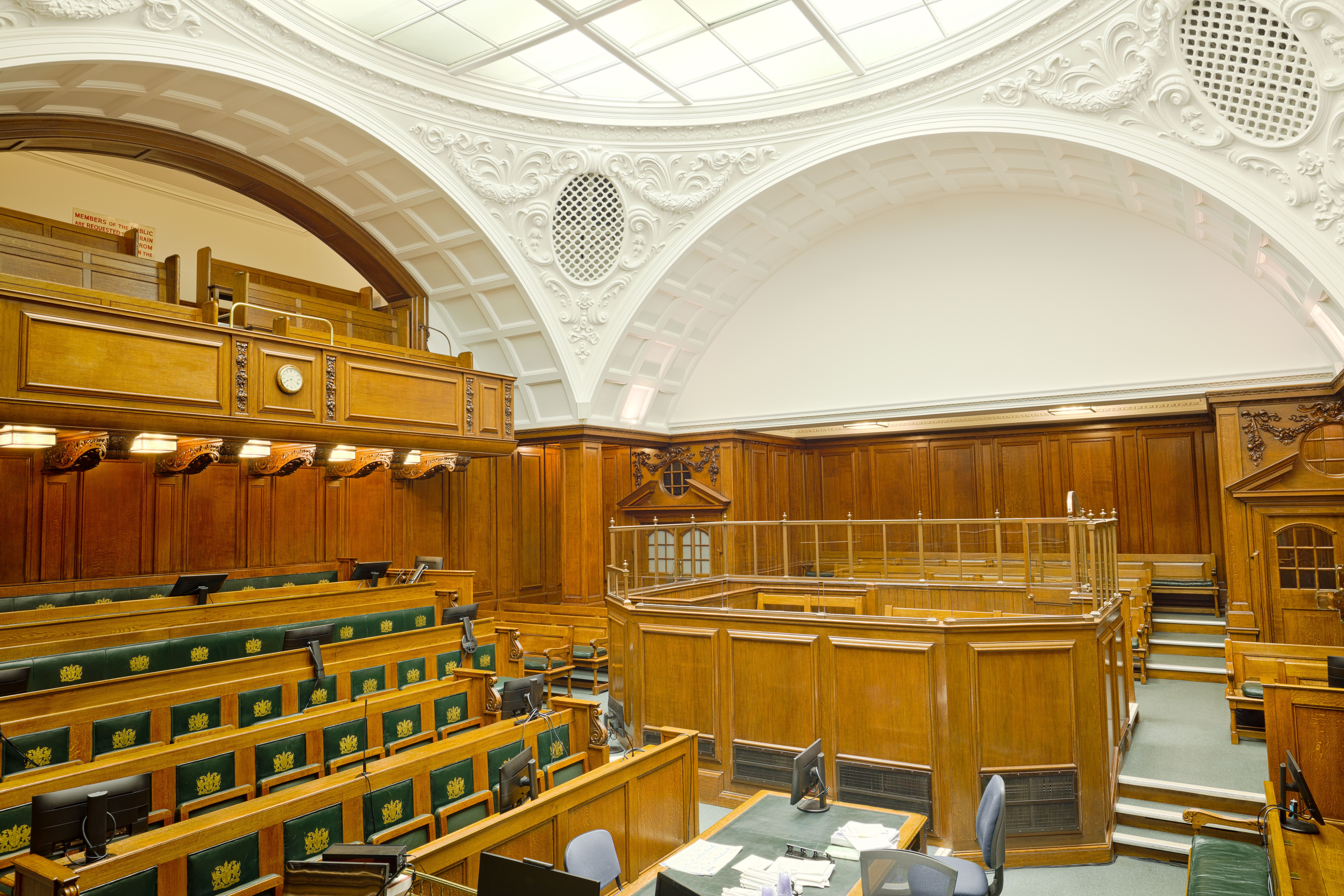 Interior view of a historic London courtroom with ornate wooden furnishings