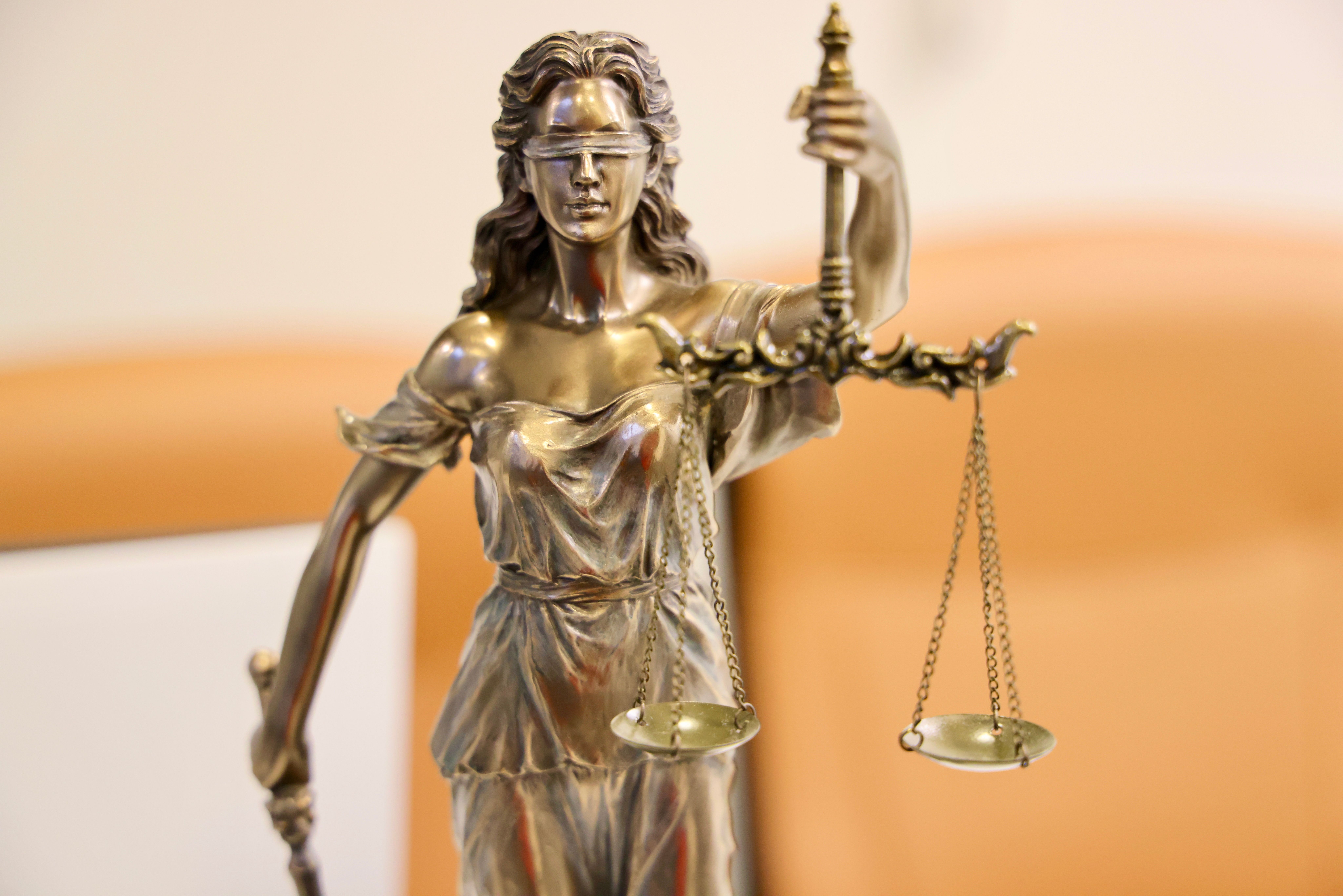 Lady Justice statue symbolising fairness and impartiality in UK legal regulation