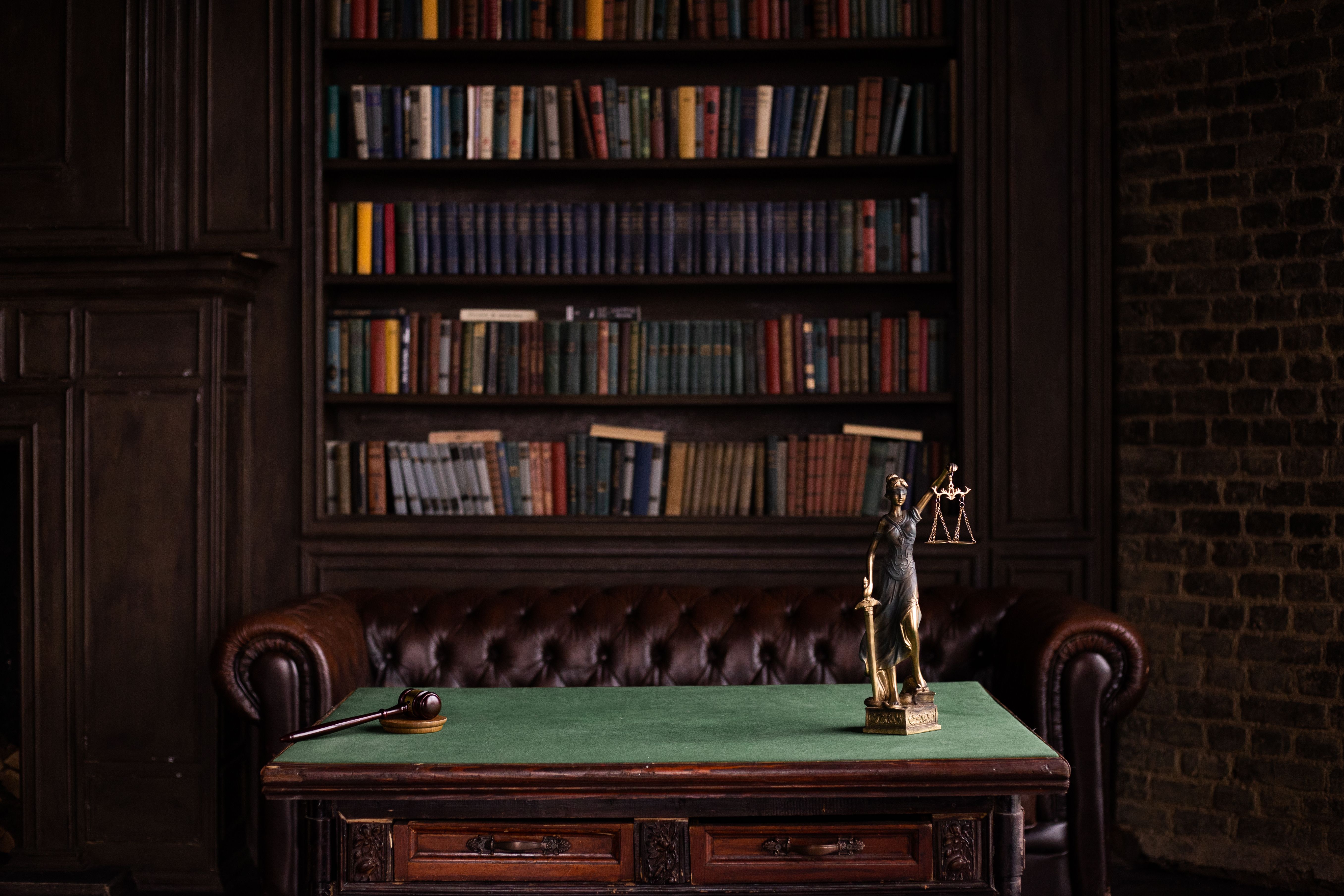 Classic legal study with law books, a gavel and Lady Justice figurine